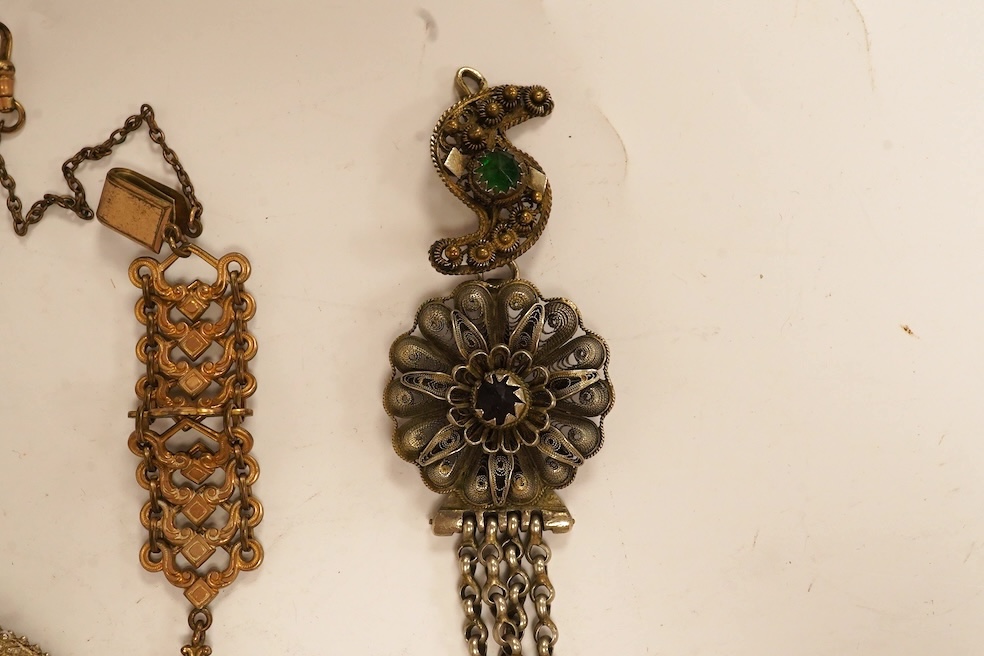 A quantity of assorted costume jewellery including an unmounted synthetic emerald, a white metal filigree bracelet, etc. Condition - poor to fair